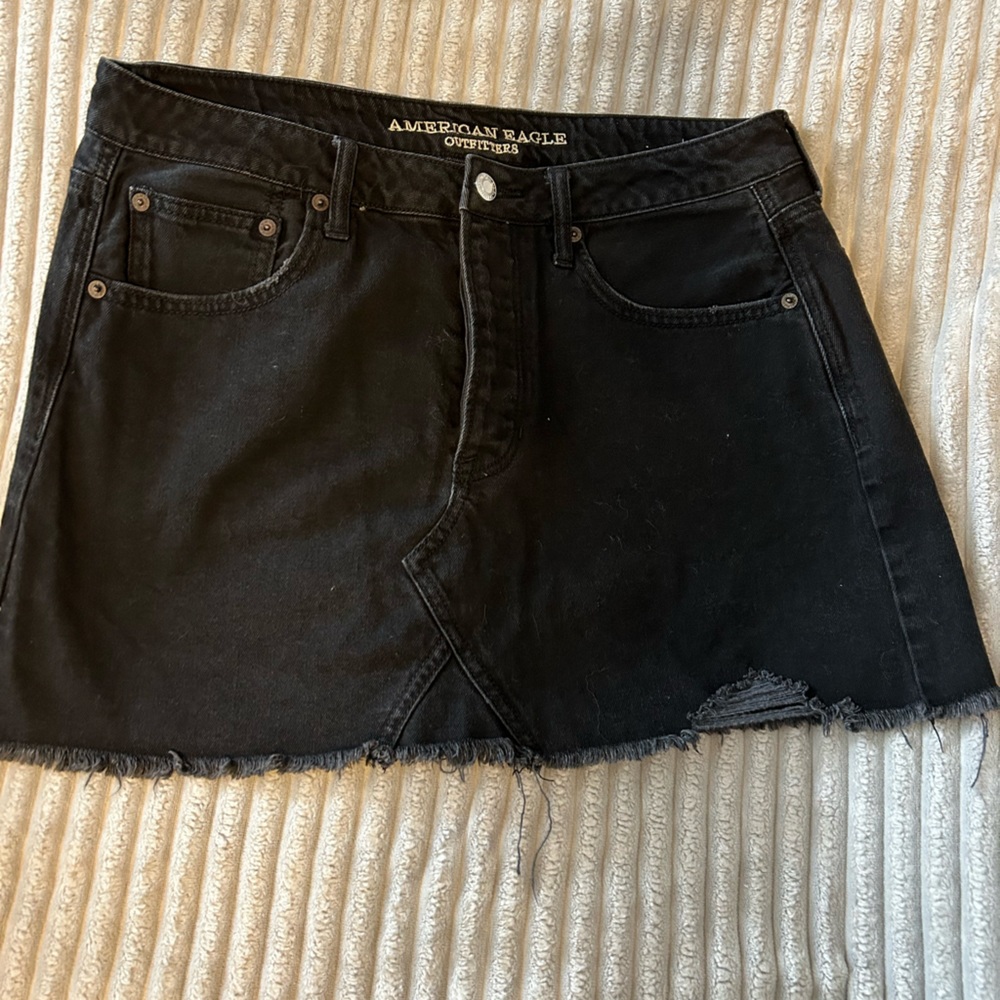 Size 12 American Eagle black denim skirt. Distressed mini skirt.